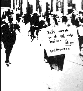 Self-insulting
                                              sign carried by a Jew